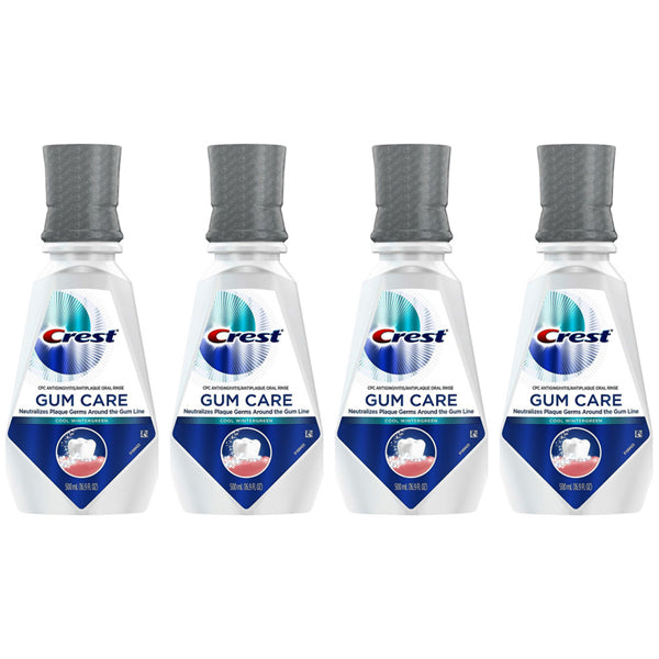 Four bottles of Crest Gum Care Mouthwash Cool Wintergreen with CPC, 16.9oz each, are arranged side by side on a white background, helping you fight plaque germs effectively.